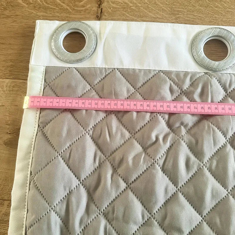 Mesure au mètre ruban d'un rideau Kurtens à œillets et doublure matelassée, contrôle qualité sur mesure