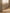 Rideau tamisant beige effet lin diffusant la lumière du jour dans une chambre lumineuse